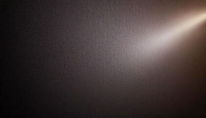 Brown textured wall with a ray of light shining from top left