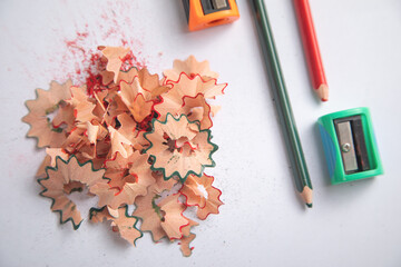 A pencil sharpener with a pencil and pencil shavings.