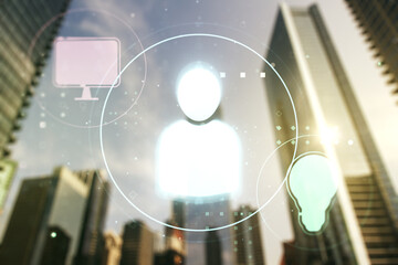 Double exposure of abstract virtual social network icons on modern skyscrapers background. Marketing and promotion concept