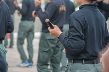 Fototapeta na wymiar Female riot police practice using batons to control crowds. 