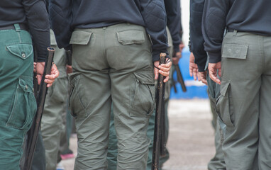 Female riot police practice using batons to control crowds.
