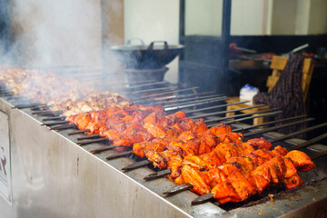 Skewers of shish kebab and chicken cooked on a grill near Ampel area in Surabaya, Indonesia.