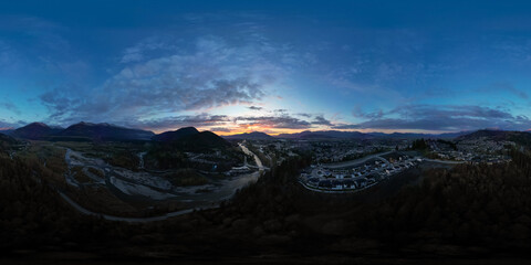 360 Aerial View of the River and Mountains. Dramatic Cloudy Sky.