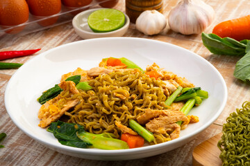 Stir fried instant Japanese style vegetable noodles with Soy Sauce and chicken breast in white plate.Asian food with low calories and healthy food.Thai style