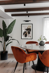  dining room with orange velvet chairs, white walls and wooden beams on the ceiling. A large plant in a black pot stands near the wall. There is an artwork hanging above of a round marble table. - obrazy, fototapety, plakaty
