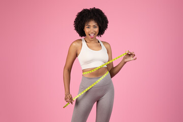 Excited woman showing off waist size