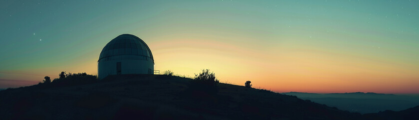 Atmospheric stock image of a quiet observatory at twilight, the dome silhouetted against a gradient...