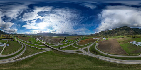 Aerial 360 Panorama of Highway, Farms and Mountain Landscape.