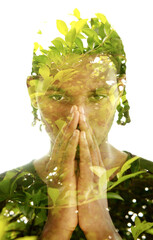 Double exposure portrait of a young man combined with green tree branches photo - 779035510
