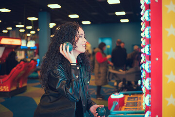 Woman enjoying arcade games at a lively indoor entertainment center