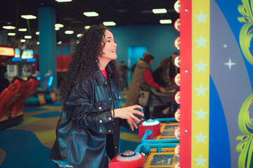Woman enjoying arcade games at a lively indoor entertainment center