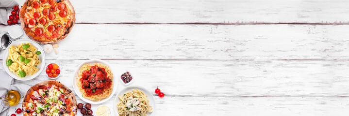 Delicious Italian food corner border. Various pizzas and pastas. Overhead view on a white wood banner background. Copy space. - 779043902