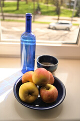 still life with apples near the window