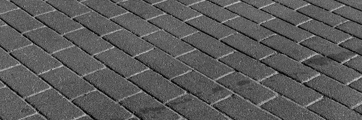 Panoramic image. Black stone pavement texture, cobbled street