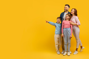 Family with two kids pointing and smiling