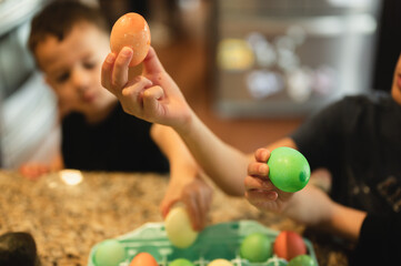 Children holding dyed Easter eggs in celebration of the Easter holiday, family holiday activity concept
