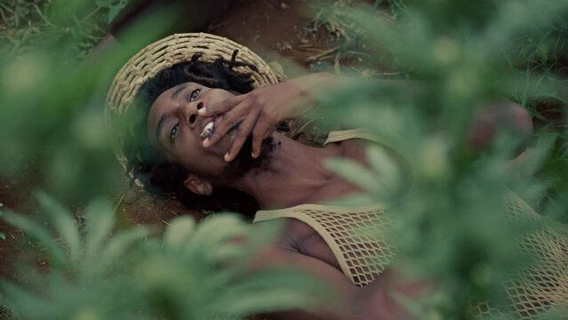 Man Smoking Weed while laying on the ground