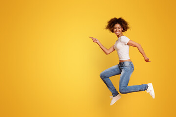 Fototapeta na wymiar Funny portrait on young african american woman in humorous jump