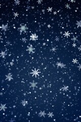 Delicate snowflakes flutter against a deep blue background in this winter scene.