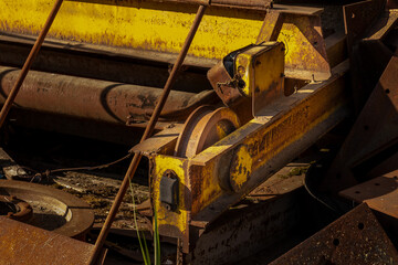 crane beam lying in scrap metal or a dump of lifting equipment