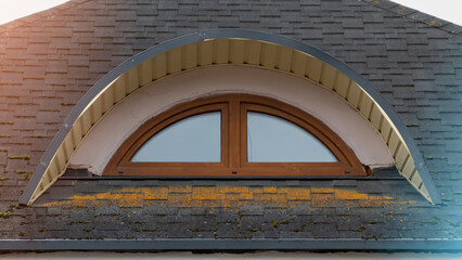 attic semicircular brown plastic window close-up