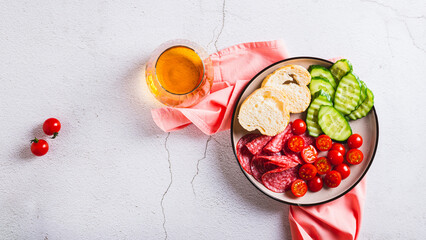 Girl dinner of smoked meats, vegetables and bread on a plate on the table top view web banner