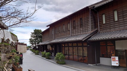 Kagoshima, Japan - 01.29.2020: A walkway along shops in traditional Japanese architecture in Sengan-en under a cloudy sky