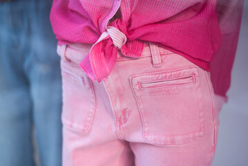 Closeup of pink pants and pink shirt on mannequin in a fashion store showroom - 779058715