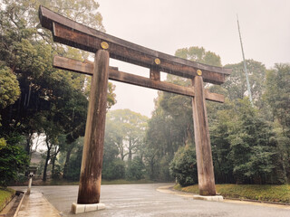 A rainy day in Tokyo Meiji Jingu Gyoen, Meiji Park, Japan. Traditional Japanese Torii gate in the park.