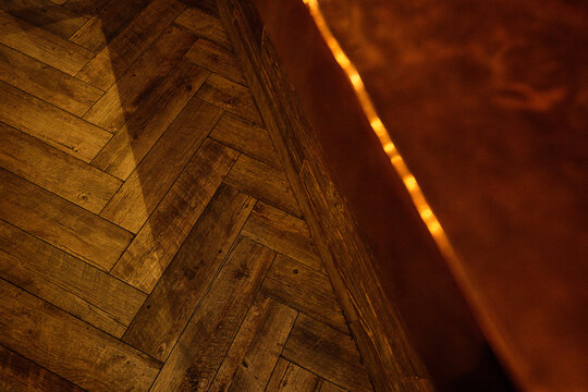 wood herringbone floor with copper bar