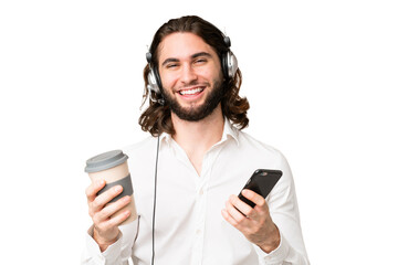 Telemarketer man working with a headset over isolated chroma key background holding coffee to take...