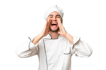 Young handsome chef man over isolated background shouting and announcing something
