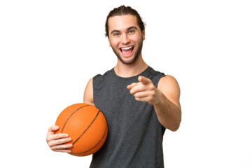 Young basketball player man over isolated background surprised and pointing front