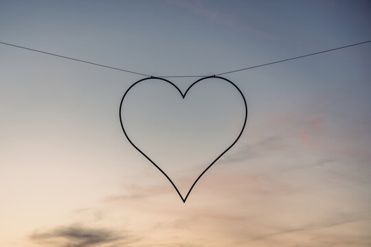 Heart-Shaped Silhouette Hanging Against a Serene Twilight Sky