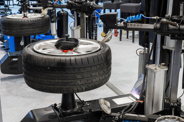 Car wheel balancing device for tire fitting.