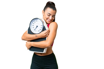 Young beauty woman over isolated chroma key background with weighing machine - 779074706