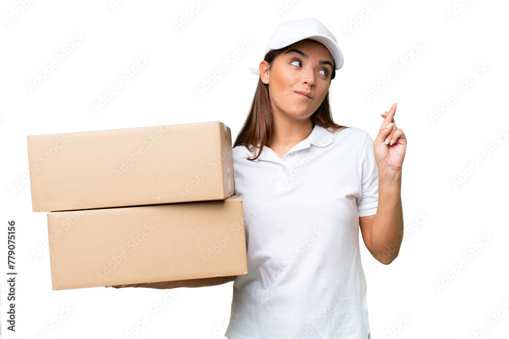 Canvas Prints Delivery caucasian woman holding boxes isolated on green chroma background with fingers crossing and wishing the best