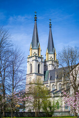The spire of an ancient church tower with a clock on the territory of Admont Abbey