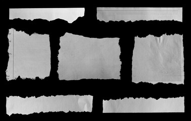 Seven pieces of torn newspaper on black background