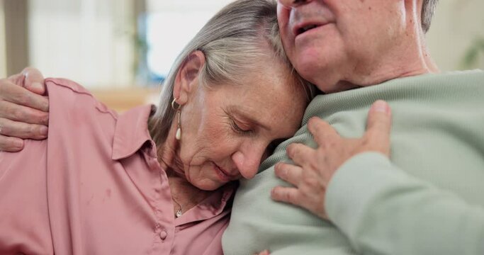 Sad, hug and senior couple with support and empathy for partner with depression in home from cancer. Elderly, man and embrace woman with care, kindness or sympathy for grief in retirement or marriage