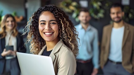 Smiling Professional Woman Holding Laptop with Colleagues in Background. Casual Business Environment Portrait. Confident Team Member at Work. AI