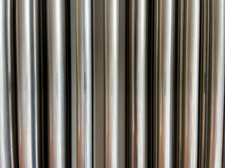 Silver background of corrugated metal seamless pipe
