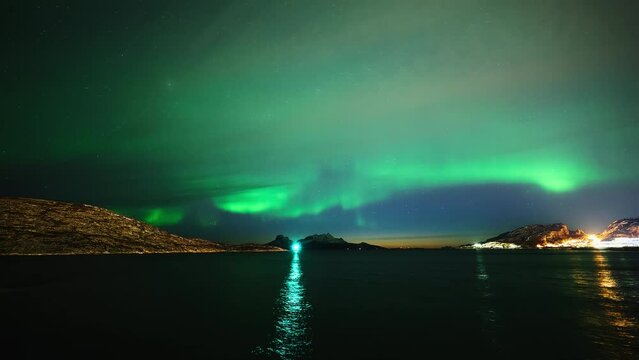 A distant aurora captured above the iconic mountainous island Landegode north of Bod&oslash; in early April 2024. Clouds are starting to cover the night sky, creating a beautiful dramatic scene.