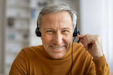 Senior man with headphones have video call