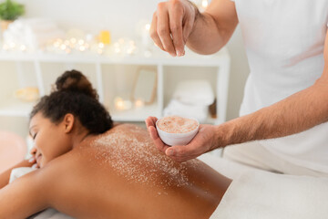 Obraz na płótnie Canvas Applying exfoliating scrub during spa treatment at spa