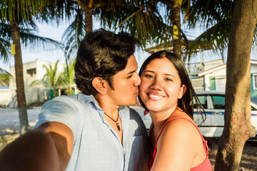 Latin american couple taking a selfie.