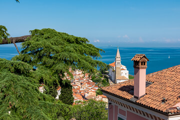 Red rooftop and Saint George Church with panoramic aerial view of coastal town Piran, Primorska,...