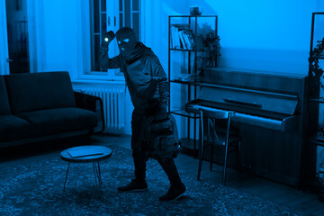 Lone figure in a room with a piano at night