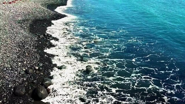 Top view aerial image from drone of stunning beautiful sea landscape beach with turquoise water with copy space for  text. Beautiful black Sand beach with turquoise water, aerial UAS drone shot
