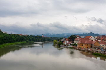 Fototapeta na wymiar Breathtaking panorama of glistening Drava River as it gracefully winds its way through enchanting city of Maribor, nestled in heart of Slovenia, Europe. Timeless beauty of old town along riverbed